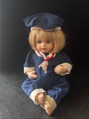 8” Porcelain Baby Doll with Blonde Hair & Blue Sailor Outfit.